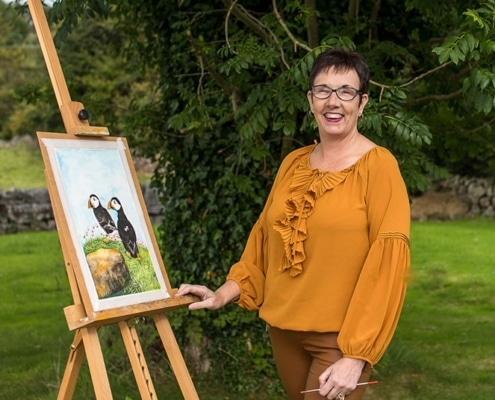 Award Winning Galway Artist Pat Flannery in her Garden Painting.jpeg