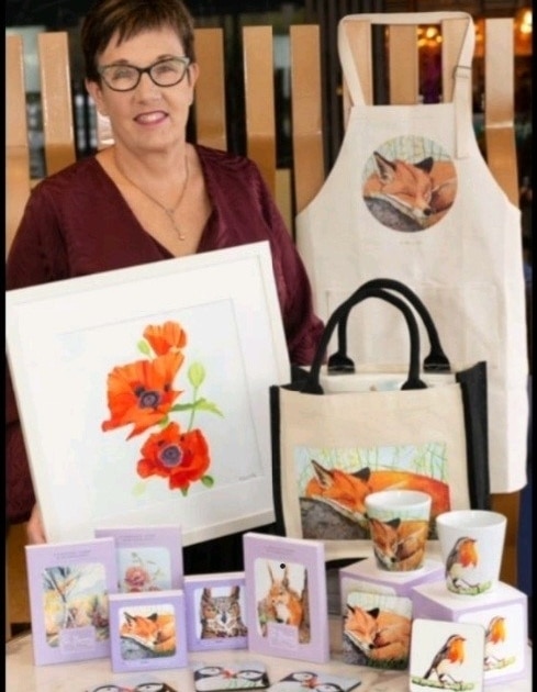 This photo showcases a selection of Pat Flannery's Art and Homewares Range. This includes her Wildlife Collection of Latte Mugs, Coasters, Tote Bags, Aprons & Blank Greeting Cards